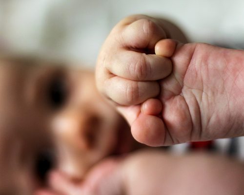 baby holding a foot