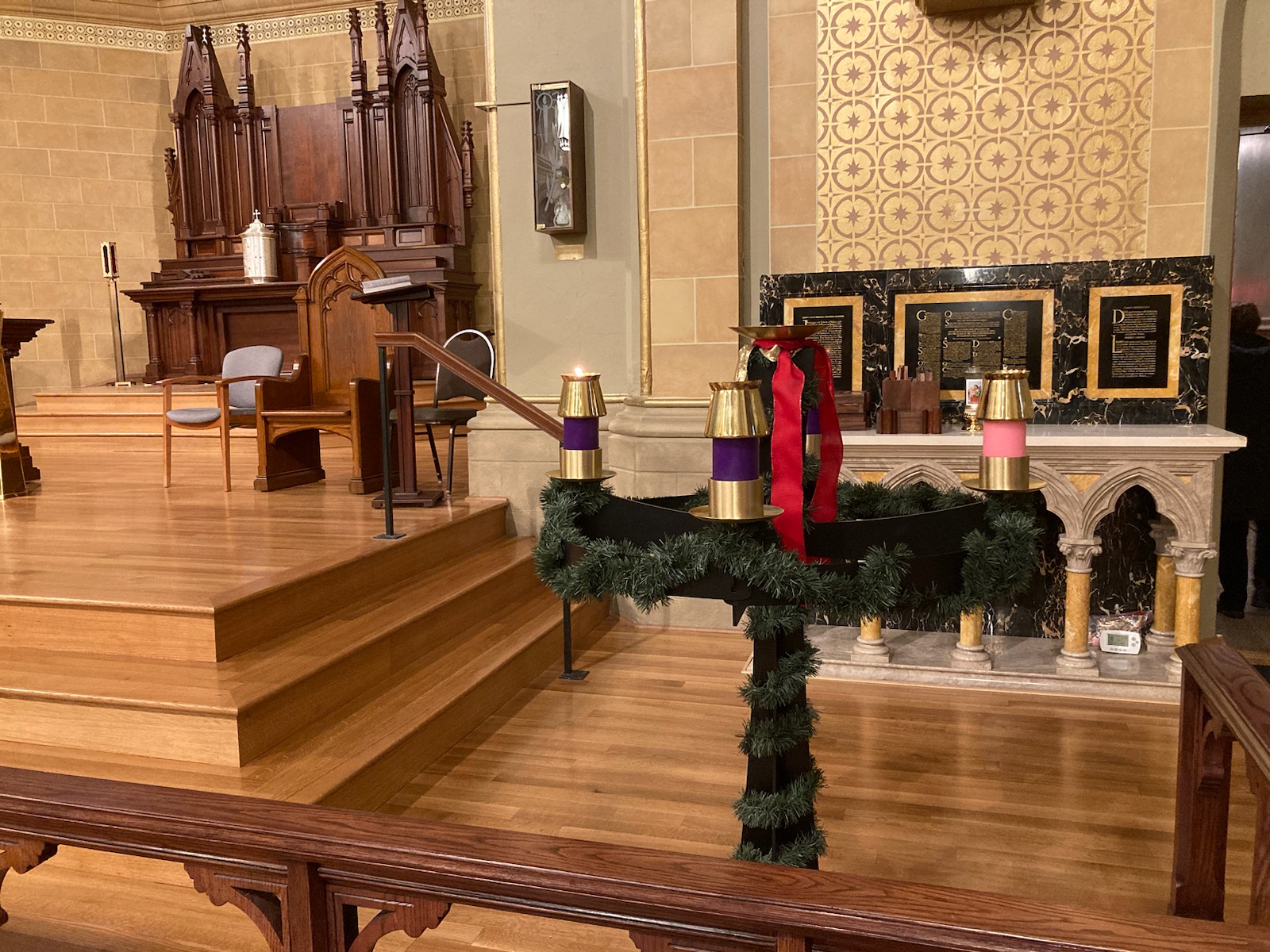 Advent wreath near altar with purple candle lit